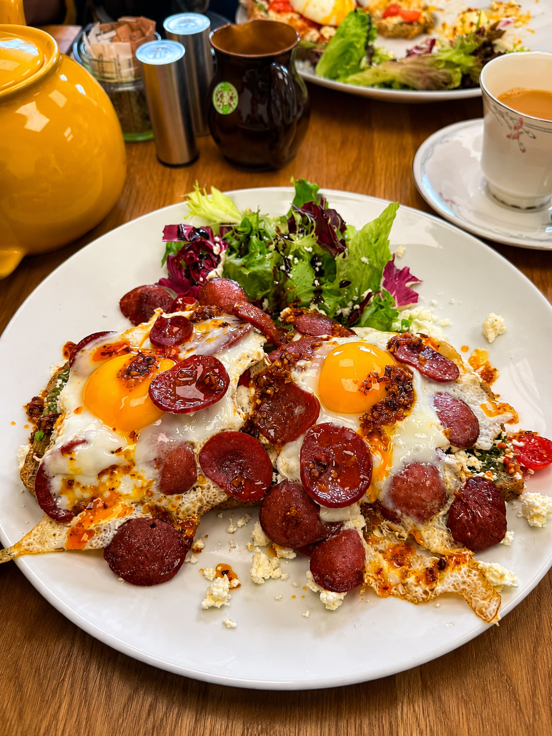Fried eggs with sausage and salad served at The Nook Cafe